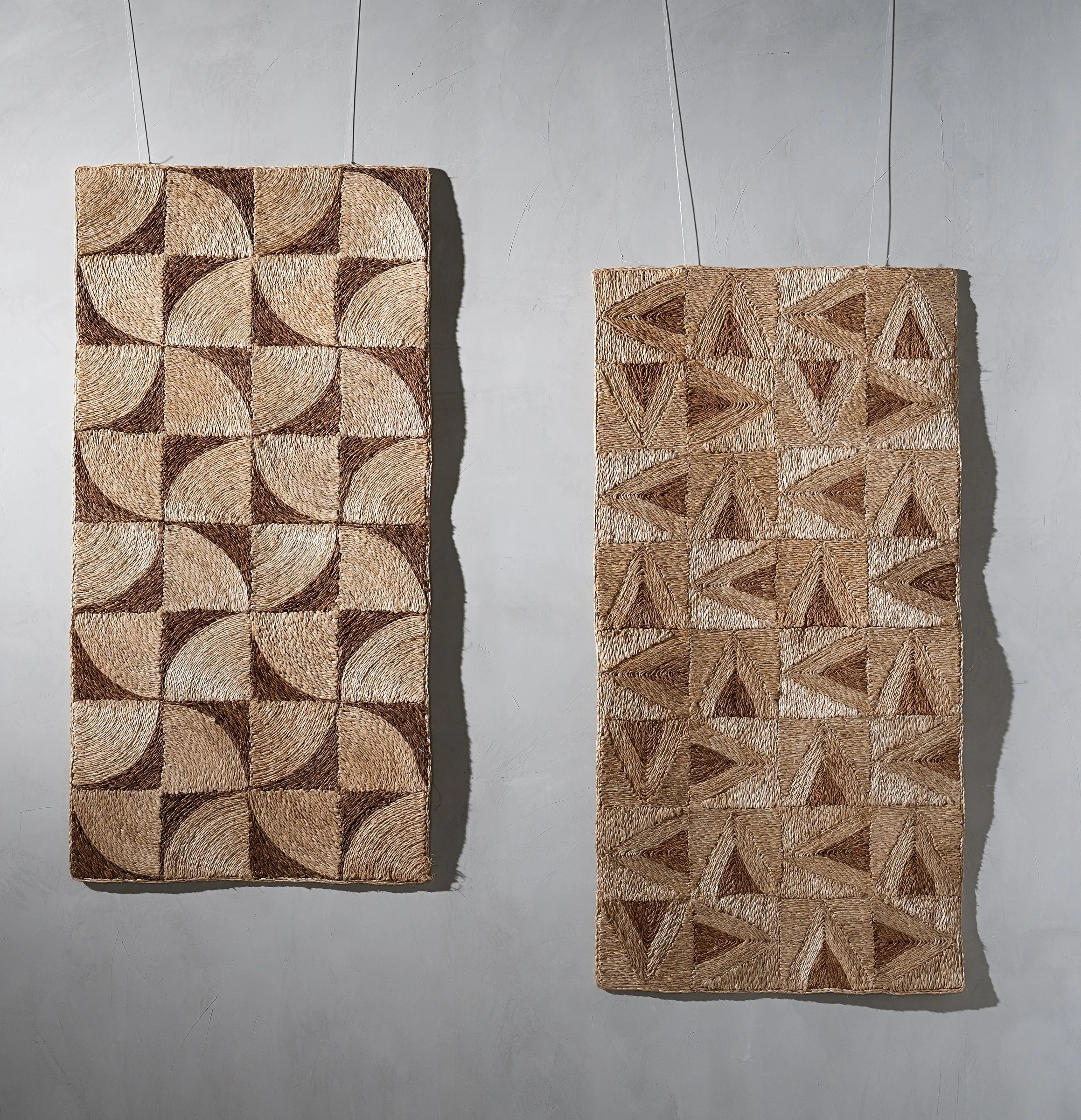 Two art weave panels hung in gallery light