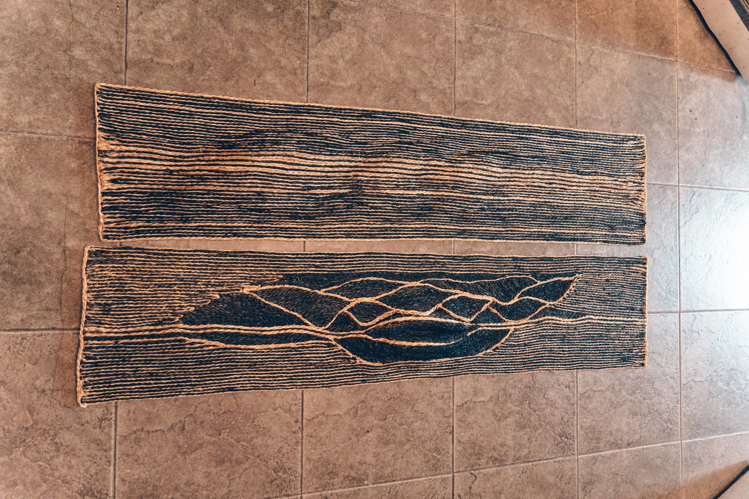 Art weave runner on tiled floor